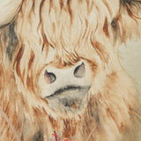 Close-up of the Bramble Highland Cow cushion showing hand-painted print detail of shaggy amber and brown fur framing the cow's face on beige polyester fabric.
