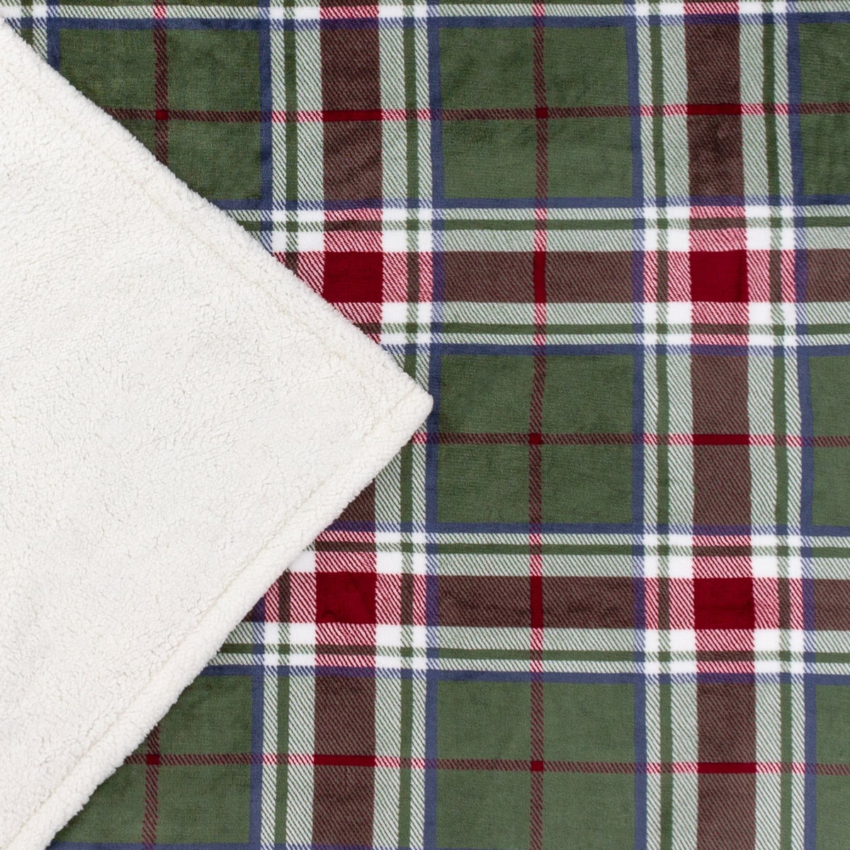 Braemarcheck polyester throw in red and green tartan check, folded corner showing soft cream Sherpa fleece reverse, fabric material.