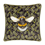 Braywick Animal Velvet Cushion in the Bee design, a square black cushion with a printed bumblebee motif amid oak leaves and acorns, finished with green piping, shown on a plain white background.