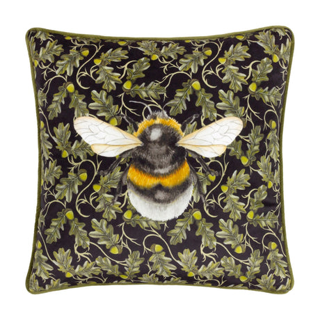 Braywick Animal Velvet Cushion in the Bee design, a square black cushion with a printed bumblebee motif amid oak leaves and acorns, finished with green piping, shown on a plain white background.