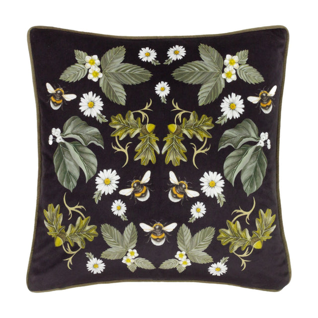 Braywick Animal Velvet Cushion in black with a mirrored floral design of daisies, leaves, acorns and bumblebees, olive green piped edges, shown on a plain white background.