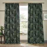 Brook Jacquard Polyester Pencil Pleat Curtains in Forest Green with a woven woodland deer and tree design, shown hanging either side of a window in a living room.