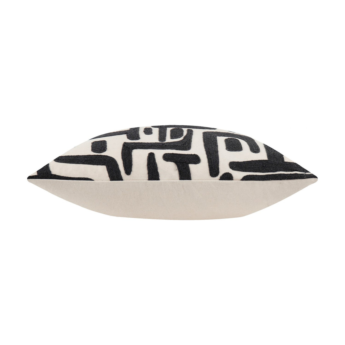 Brooke Abstract Cotton Cushion in Mono, shown side-on, with cream cotton fabric and black embroidered geometric pattern on the top edge, plain white background.