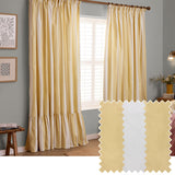 Birdie Stripe cotton pencil pleat curtains in butter yellow and white stripes with a ruffled hem, shown hanging in a bedroom window beside a fabric swatch.