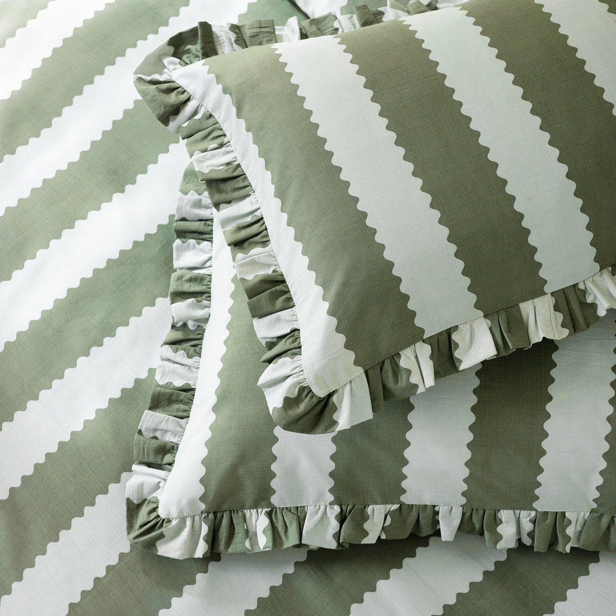 Birdie Stripe Printed Frill Trim Duvet Cover Set in Baygreen/Mist, showing bay green and white vertical stripes with scalloped edges and a gathered frill trim on the pillowcase and cover.