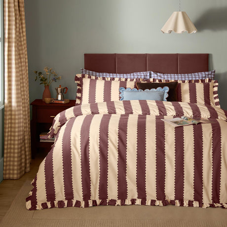 Birdie Stripe Frill Trim Duvet Cover Set in buttermilk and chocolate, with scalloped-edge vertical stripes and gathered frill trim, shown styled on a bed in a bedroom setting.