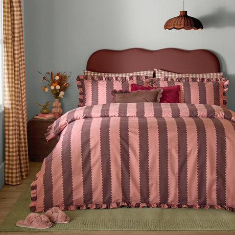Birdie Stripe Printed Frill Trim Duvet Cover Set in rose and chocolate, styled on a bed with gingham pillowcases against a soft blue bedroom wall.