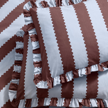 Birdie Stripe cotton blend pillowcase pair in blue and chocolate, featuring bold vertical stripes with scalloped edging and gathered ruffle trim on each side.