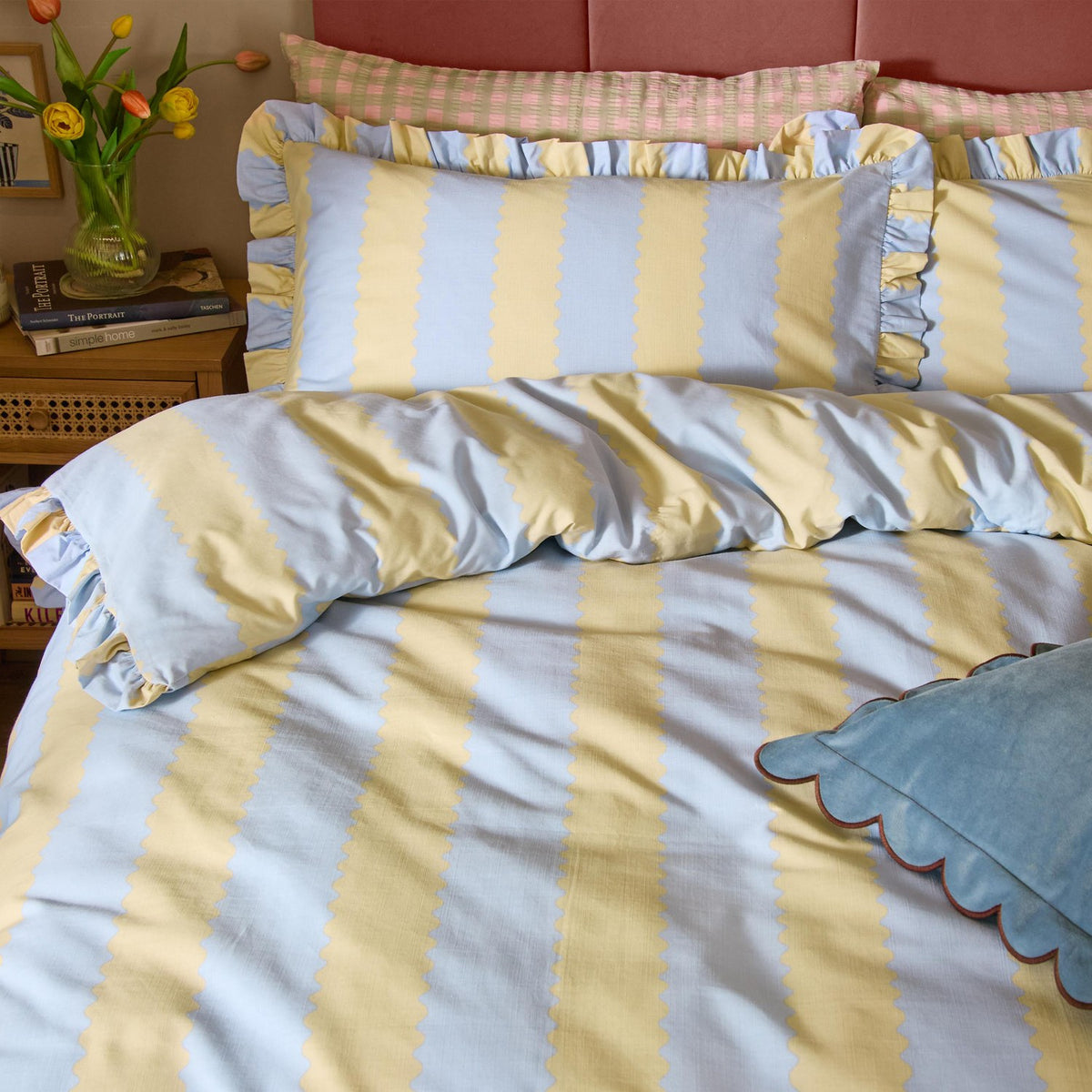 Birdie Stripe Frill Trim Cotton Blend Pillowcase Pair in Lemon/Sky, shown on a bed with scalloped-edge striped duvet cover and ruffled trim, styled with cushions in a bedroom setting.
