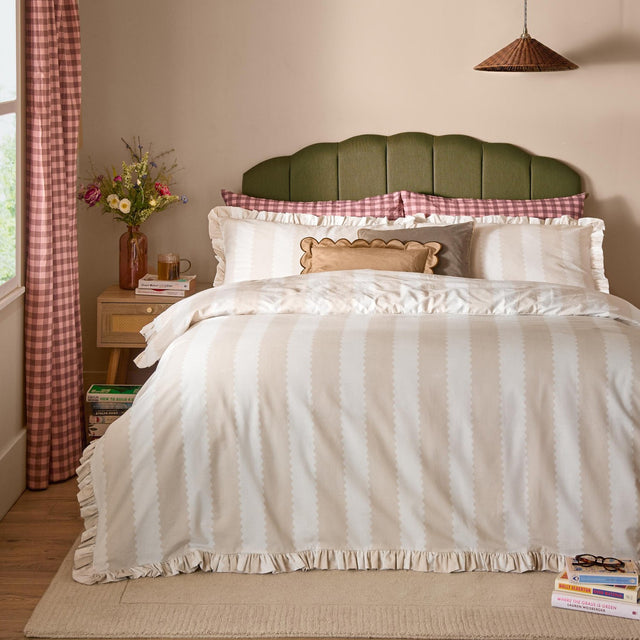Birdie Stripe Printed Frill Trim Duvet Cover Set in oat/milk with vertical stripes and gathered frill edges, styled on a bed with pillows in a bedroom setting.