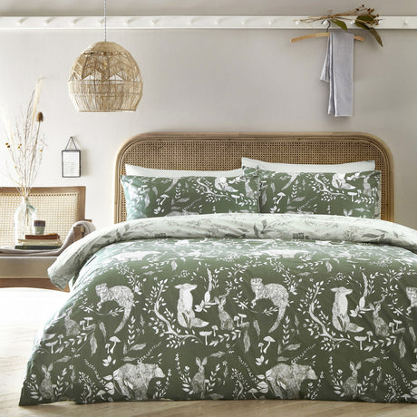 Buckthorn Reversible Animal Duvet Cover Set in Evergreen, featuring a hand-drawn woodland print of rabbits, foxes and bears among foliage, with matching pillowcases.