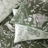 Buckthorn Reversible Animal Duvet Cover Set in Evergreen, showing pillowcases and duvet with hand-drawn foxes and bears among foliage on green and sage polycotton.