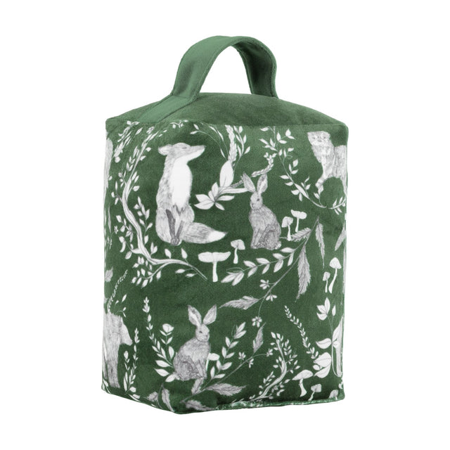 Buckthorn Animal Velvet Door Stop in evergreen, a fabric doorstop with carry handle printed with grey and white fox, rabbits, owl and bear among leaves and toadstools, shown on a white background.