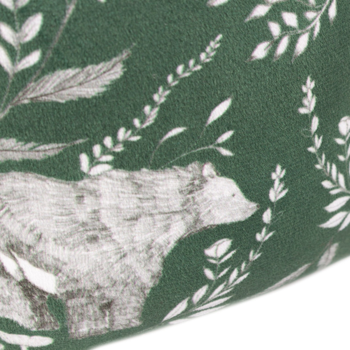 Close-up of the Buckthorn Animal Velvet Door Stop in Evergreen, showing a hand-drawn bear among leaves and ferns on deep green velvet fabric.