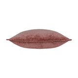 Side view of the Buxton reversible cushion in heather, showing a chenille-style woven polyester texture in dusky rose-pink, piped edge, and plump square shape on a white background.
