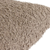 Close-up of the Cabu Reversible Wool Cushion in taupe, showing its chunky bouclé fabric with a soft, curly shearling-look pile against a plain white background.
