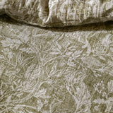 Cademuir Cotton Woodland Duvet Cover Set in Sage, close-up of muslin fabric with white toile print of birds, hares and leaves on a sage green ground.