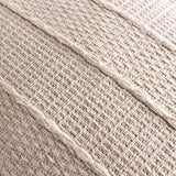 Close-up of the Caliche Plain Cotton Cushion in natural cream, showing woven cotton texture with braided stripes bordering alternating flat and open basket weave panels.