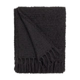 Candar Plain Polycotton Throw in black, folded to show a boucle-textured weave and hand-knotted fringe edge, set against a plain white background.