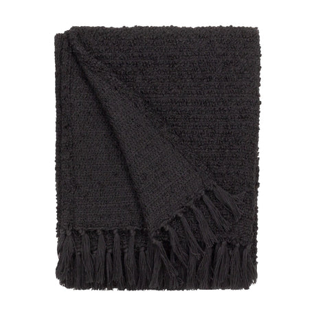 Candar Plain Polycotton Throw in black, folded to show a boucle-textured weave and hand-knotted fringe edge, set against a plain white background.