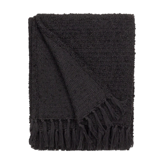Candar Plain Polycotton Throw in black, folded to show a boucle-textured weave and hand-knotted fringe edge, set against a plain white background.