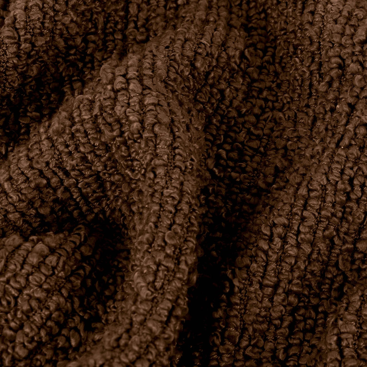 Close-up of the Candar Plain Polycotton Throw in cocoa brown, showing its boucle-woven, looped texture draped in soft folds.