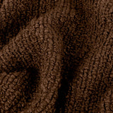 Close-up of the Candar Plain Polycotton Throw in cocoa brown, showing its boucle-woven, looped texture draped in soft folds.