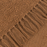 Close-up of the Candar Plain Polycotton Throw in ginger, showing its boucle-textured weave and hand-tied fringe edge in a warm brown tone.