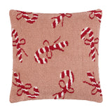 Square tufted cotton cushion in pink with a scattered red and white candy cane and bow pattern, shown on a plain white background.