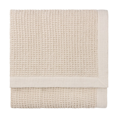 Canopy Plain Cotton Throw in natural, folded to show a chunky waffle weave with a wide plain cotton border, on a plain white background.