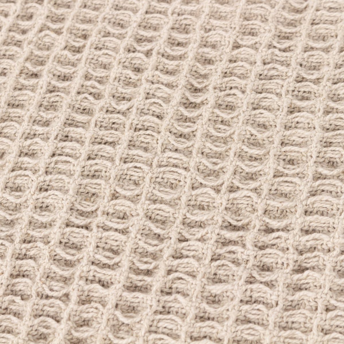 Close-up of the Canopy Plain Cotton Throw in natural beige, showing a chunky waffle weave texture in pure cotton.