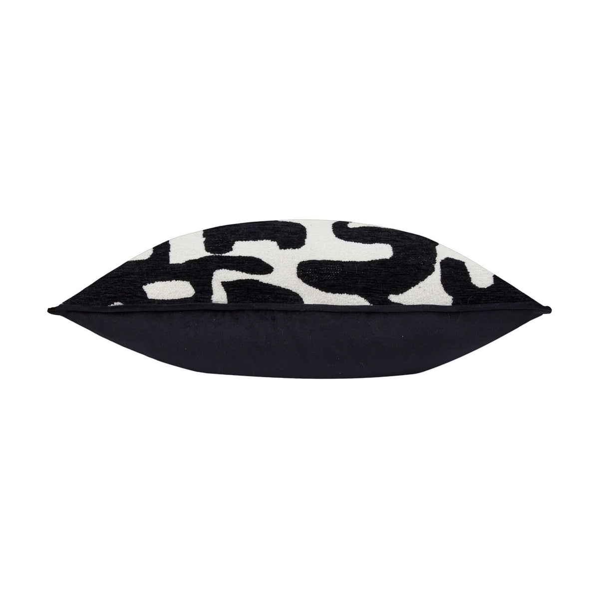 Caval Velvet Chenille Cushion in Mono, shown side-on to reveal its plump, boxed shape with black and off-white abstract jacquard front and plain black reverse, on a white background.