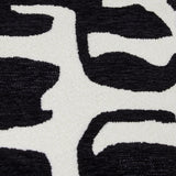 Close-up of the Caval Velvet Chenille Cushion in Mono, showing an abstract black jacquard pattern with textured boucle and smooth chenille on an off-white ground.