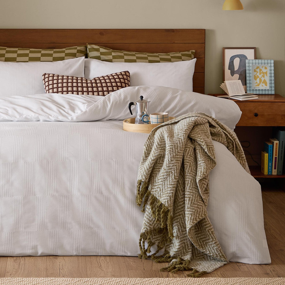 Club Checkerboard Plain Check Duvet Cover Set in white waffle-textured cotton-polyester, styled on a bed with olive check pillows and a herringbone throw in a wooden-headboard bedroom.