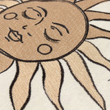 Close-up of the Celestial Stories Linen Cotton Cushion in Linen/Black, showing embroidered sun face detail with closed eyes, rays and raised black outline stitching on cream fabric.