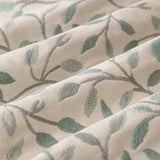 Close-up of Cervino Jacquard Pencil Pleat Curtains in Duck Egg, showing cream fabric woven with a trailing leaf pattern in soft blue, sage and tan tones.