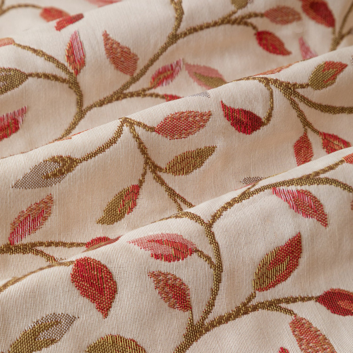 Close-up of Cervino jacquard pencil pleat curtain fabric in cream, showing woven trailing leaf and stem design in rust, terracotta, dusty pink, green and gold.