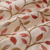 Close-up of Cervino jacquard pencil pleat curtain fabric in cream, showing woven trailing leaf and stem design in rust, terracotta, dusty pink, green and gold.