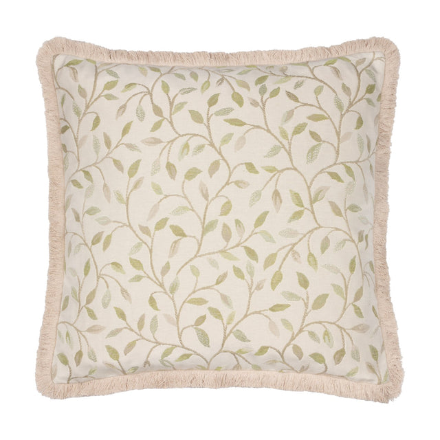 Square Cervino jacquard cotton blend cushion in cream with a woven green leaf and stem pattern, finished with a pale sandy fringe trim, on a plain white background.