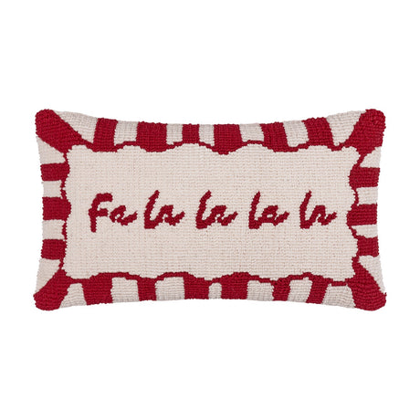 Rectangular lumbar cushion with hand-tufted "Fa la la la la" script on a cream face, framed by a red-and-white candy-stripe border, shown on a plain white background.