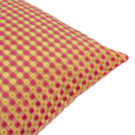 Close-up corner view of the Checkered Check Velvet Cushion in Hot Pink, showing a raised cut-velvet checkerboard pattern in pink and gold on a plain white background.