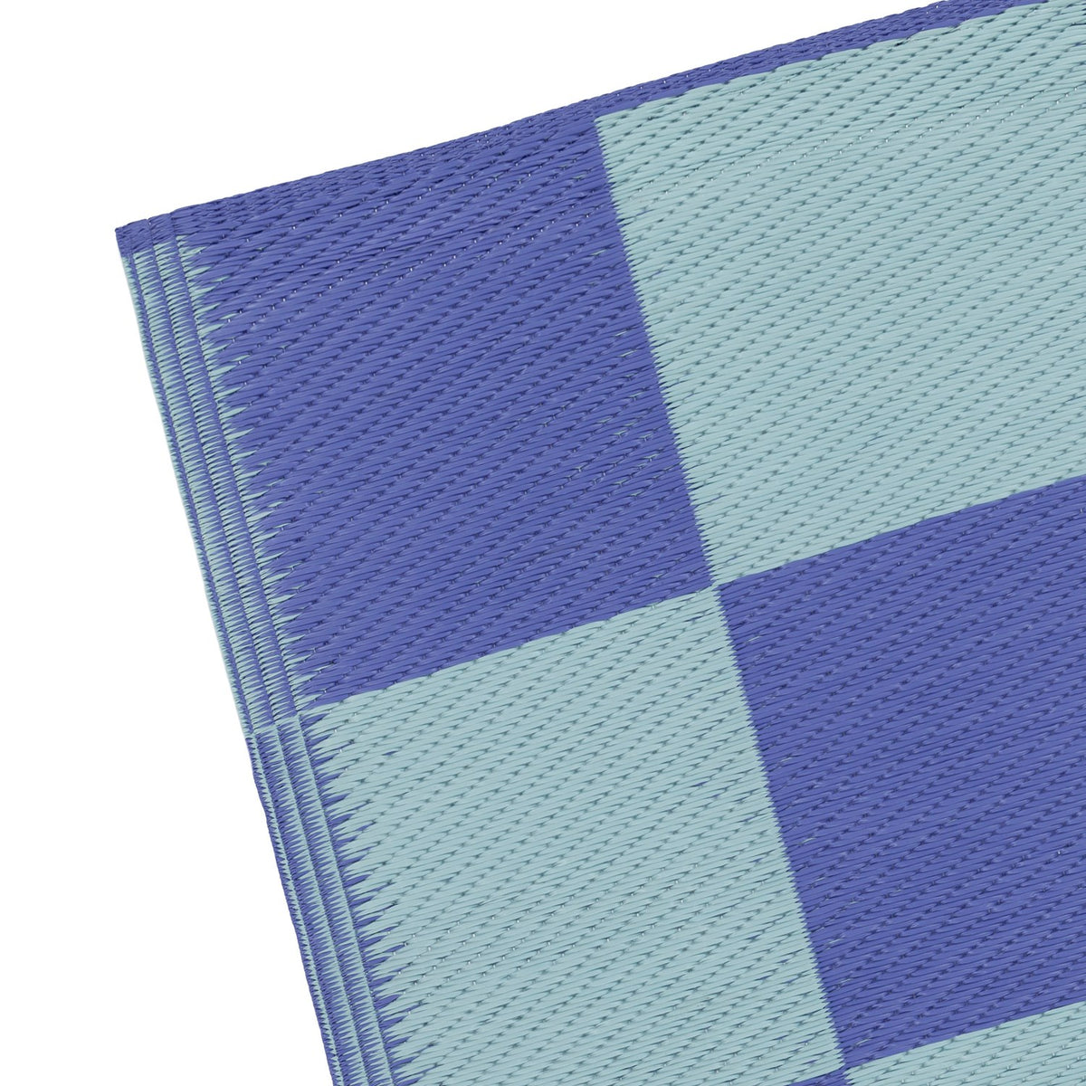 Close-up of the Checkerboard Jacquard Check Rug in blue, showing woven polypropylene texture with alternating periwinkle and duck-egg blue squares and a folded edge, on a white background.