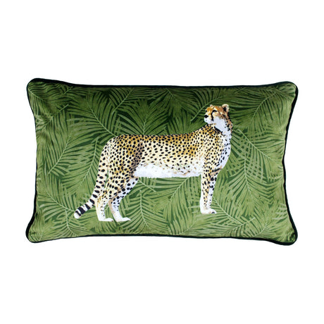Rectangular velvet lumbar cushion in green, printed with a standing cheetah in profile on a botanical leaf pattern, shown on a plain white background.