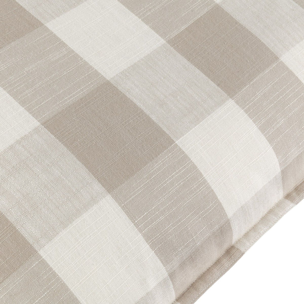 Close-up of the Chesil Check cotton cushion in natural, showing a beige and off-white check print with a woven texture and flat oxford border.