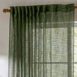 Cirrus Plain Polyester Curtain Panel in forest green, sheer slubbed-weave fabric with tab-top heading on a wooden pole, hung at a window in a bright room.