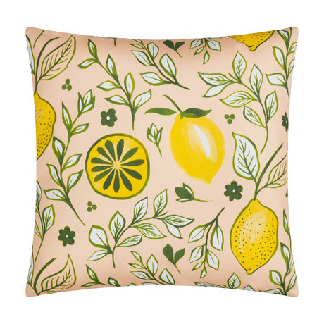 Citronello reversible polyester cushion in peach with a hand-painted lemon print, showing whole lemons, lemon slices, green vines and small flowers, on a plain white background.