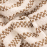 Close-up of the Clyne Check Polyester Throw in brown, showing a woven cream fabric with tan-brown check-stripe bands and a soft, textured finish.