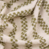 Close-up of the Clyne Check Polyester Throw in olive, showing woven check-stripe bands in soft green on a cream ground with a textured, draped finish.