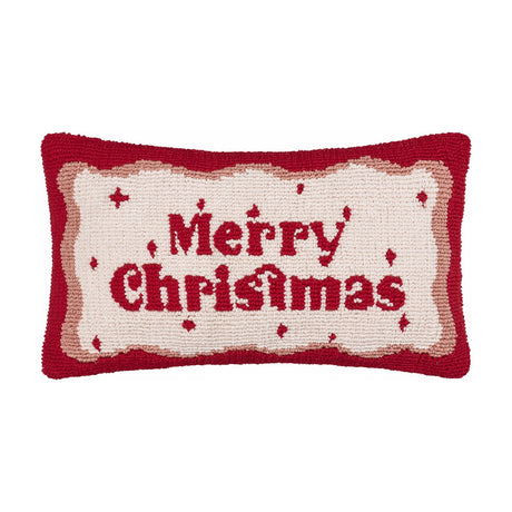 Rectangular tufted cotton cushion in cream with a red "Merry Christmas" script and a wavy red and pink border, hooked pile texture, shown on a plain white background.