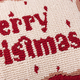Close-up of the Candy Merry Christmas Tufted Cotton Cushion, showing red hand-hooked "Merry Christmas" script on a cream ground with a red and pink wiggly border.